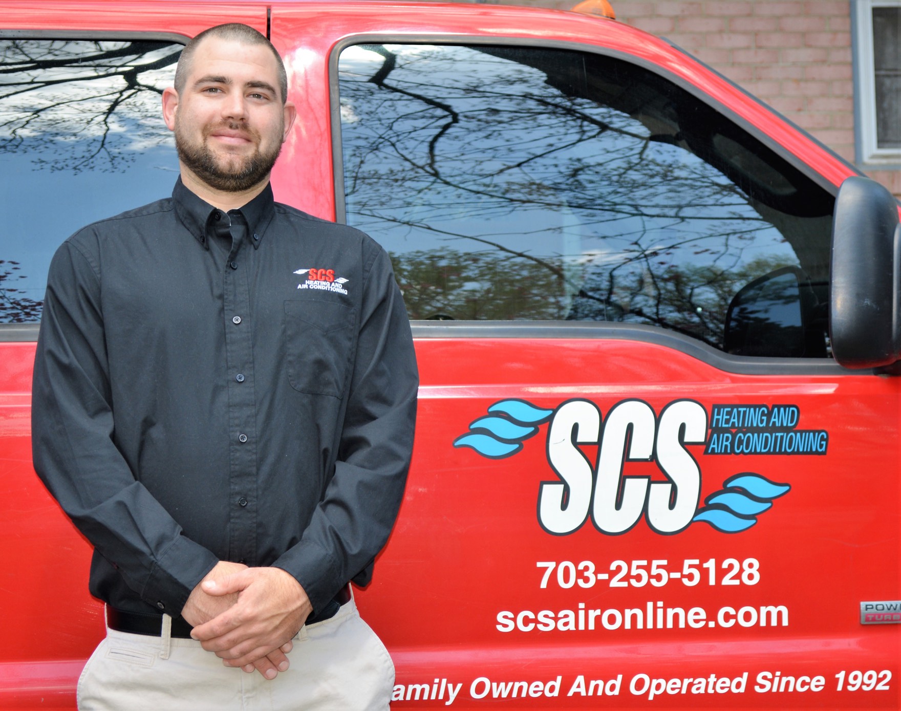 SCS technician beside the company truck